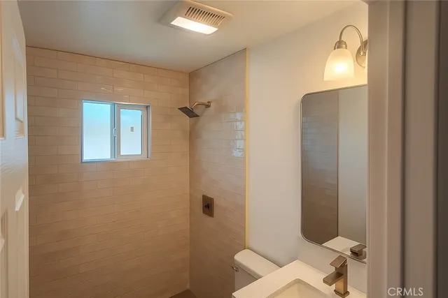 a bathroom with a shower and a toilet