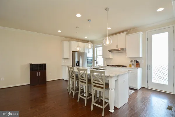 a kitchen with a table and chairs in it