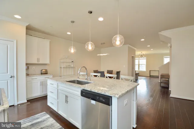 a large kitchen with kitchen island a sink stainless steel appliances and cabinets