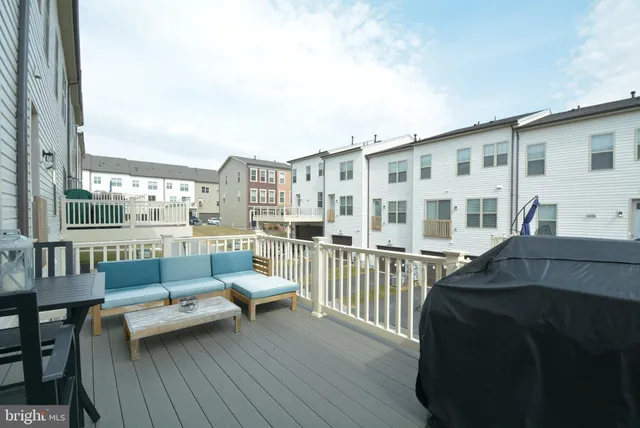 a balcony with furniture and view of city