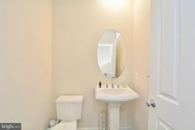 a bathroom with a sink a mirror and a toilet