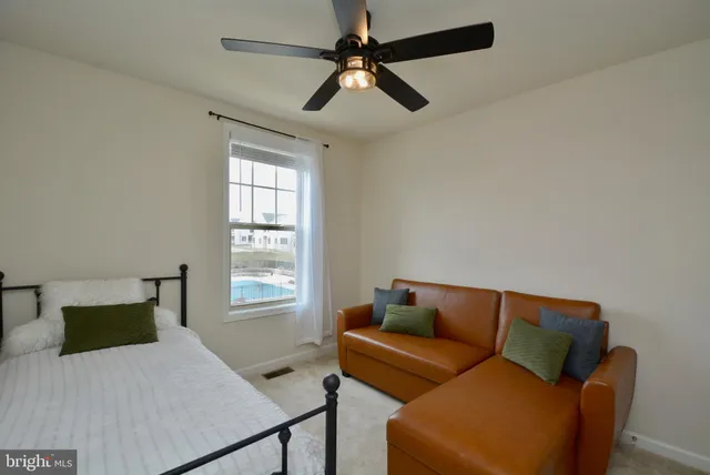 a bedroom with a bed couch and window