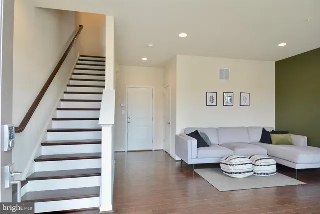a living room with furniture and stairs