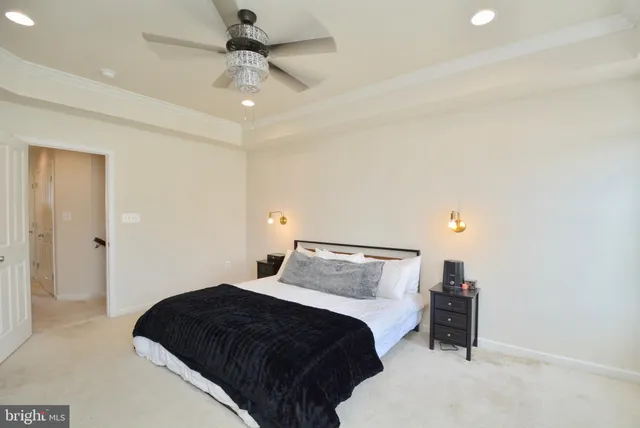 a bedroom with a bed and a ceiling fan