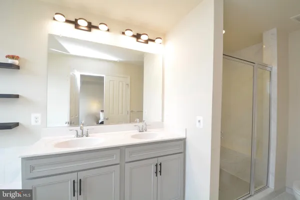 a bathroom with a sink vanity and a mirror
