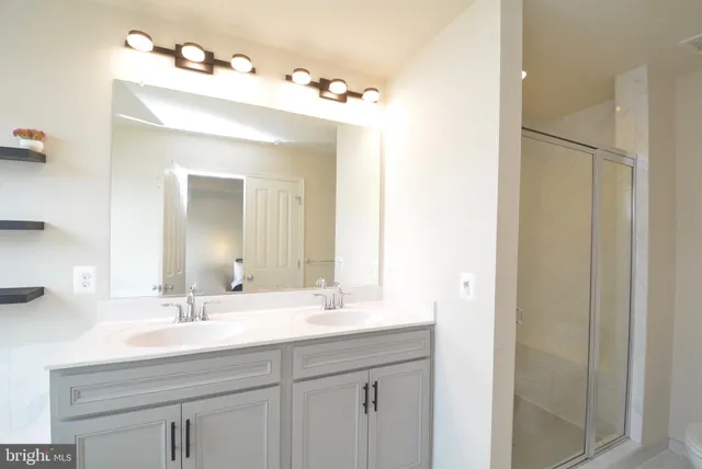 a bathroom with a sink vanity and a mirror