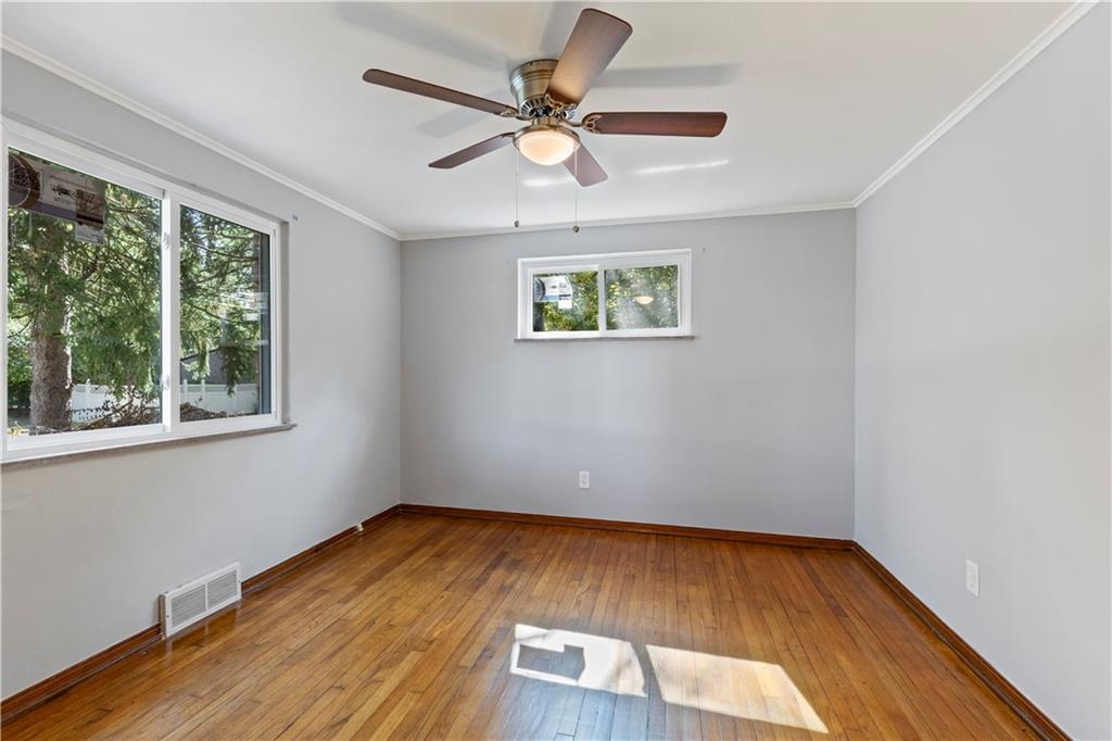 124 Saunders Station Road Trafford, PA 15085 - Photo 15 of 27 a view of an empty room with wooden floor and a window