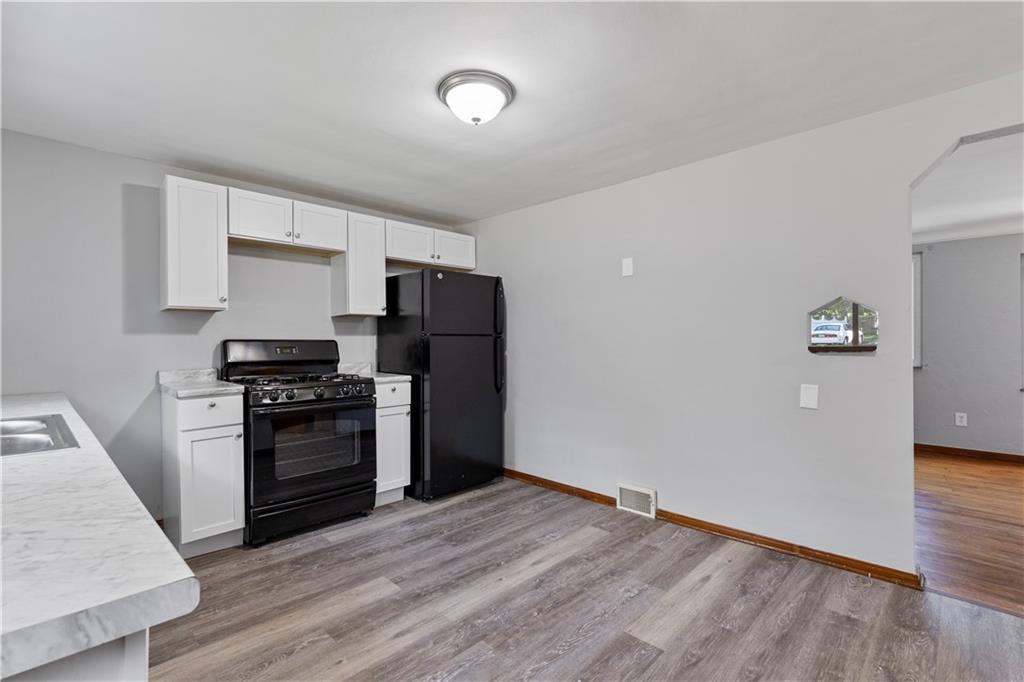 124 Saunders Station Road Trafford, PA 15085 - Photo 5 of 27 a kitchen with granite countertop a refrigerator and a stove