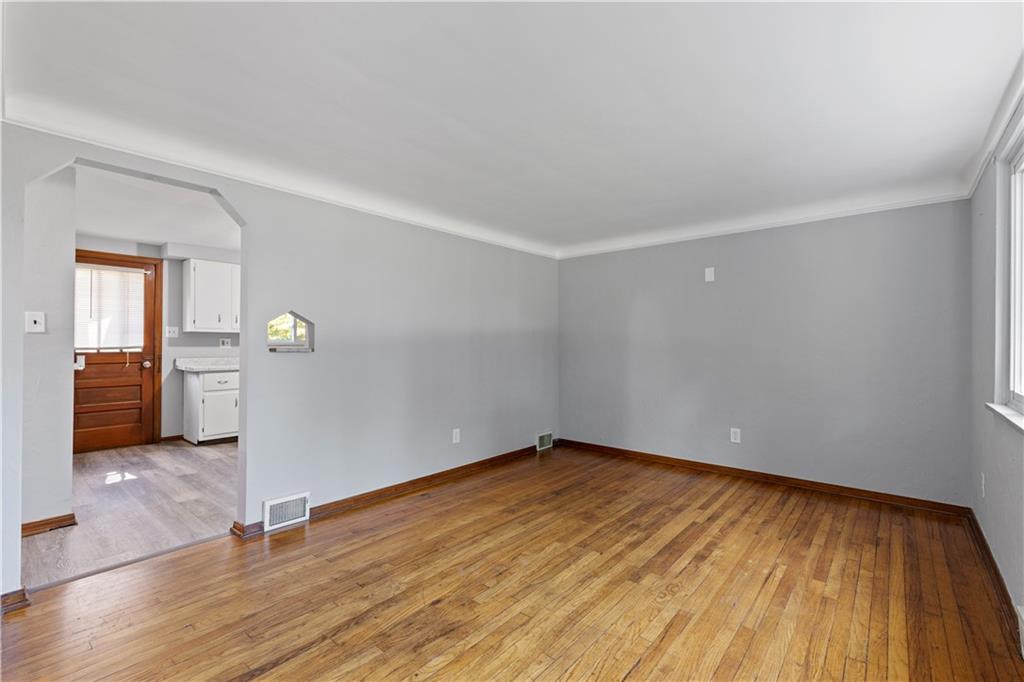 124 Saunders Station Road Trafford, PA 15085 - Photo 7 of 27 a view of empty room with wooden floor and cabinet
