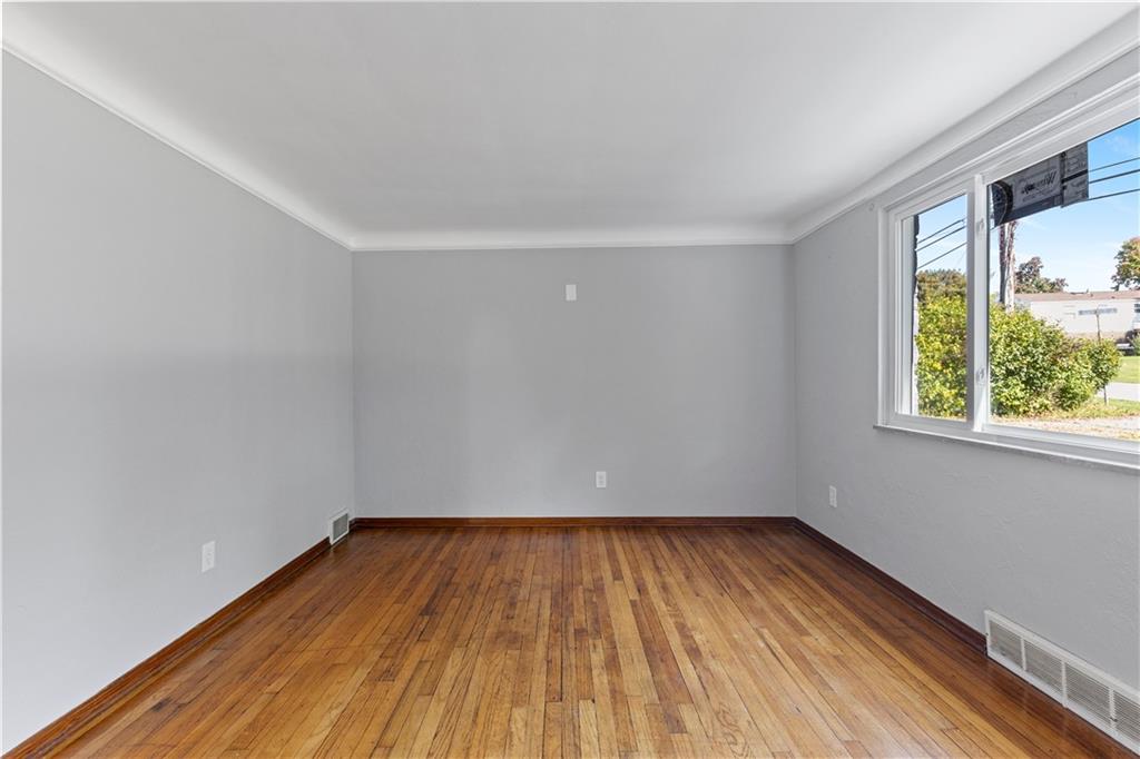 124 Saunders Station Road Trafford, PA 15085 - Photo 8 of 27 a view of empty room with wooden floor and fan