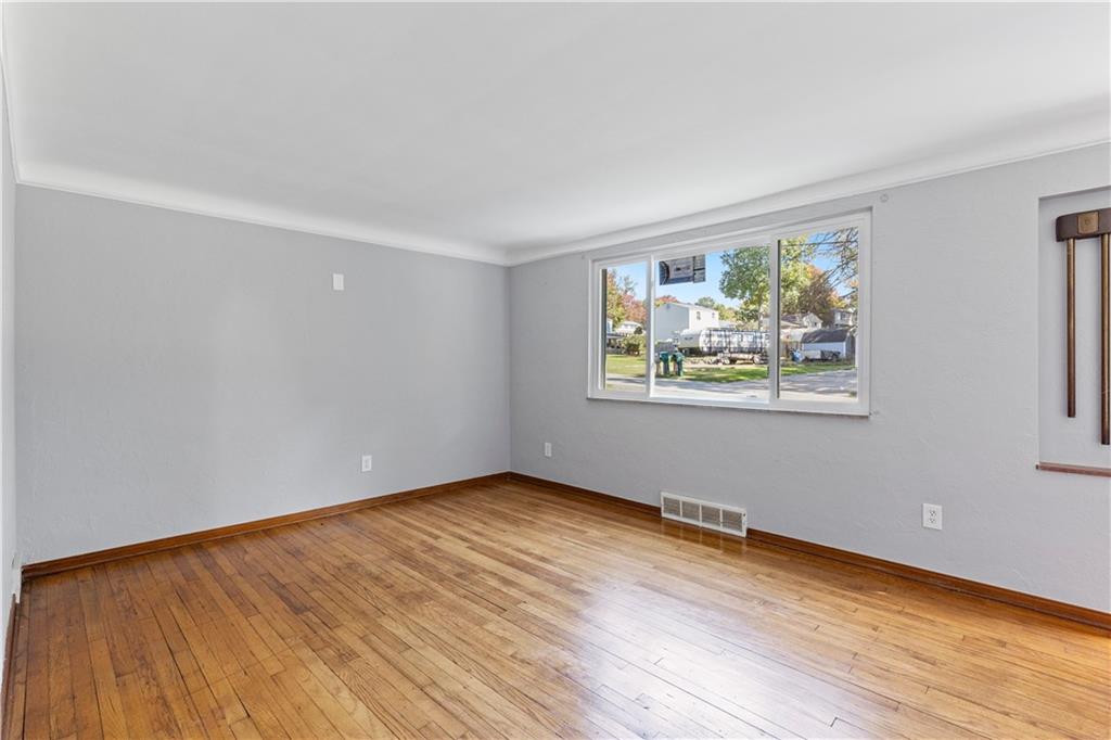 124 Saunders Station Road Trafford, PA 15085 - Photo 9 of 27 a view of an empty room with wooden floor and a window