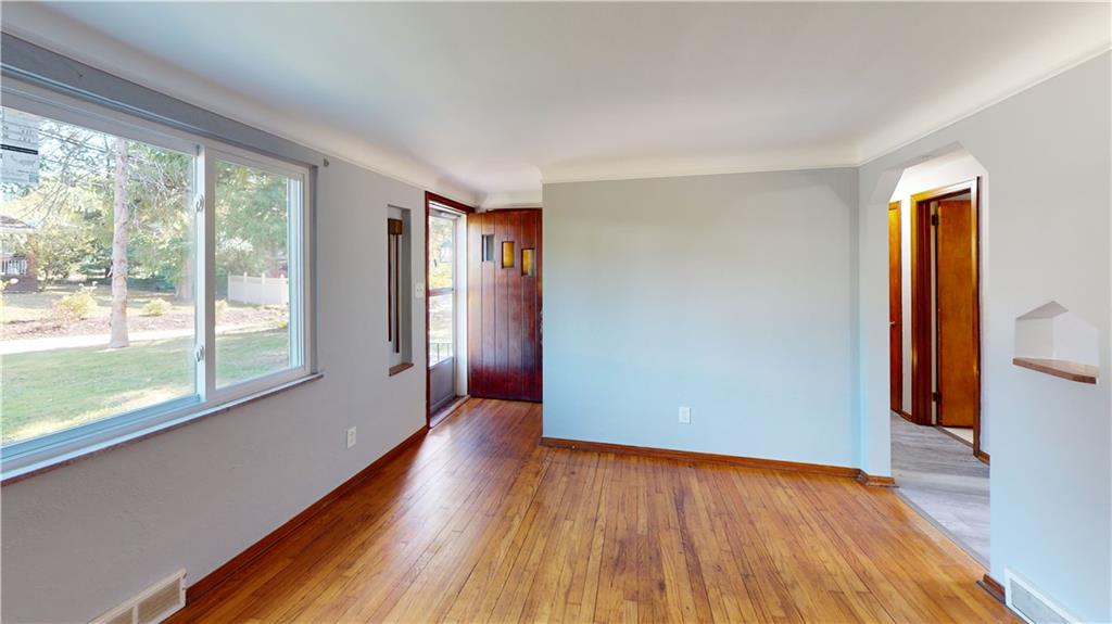 124 Saunders Station Road Trafford, PA 15085 - Photo 10 of 27 a view of an empty room with wooden floor and a window