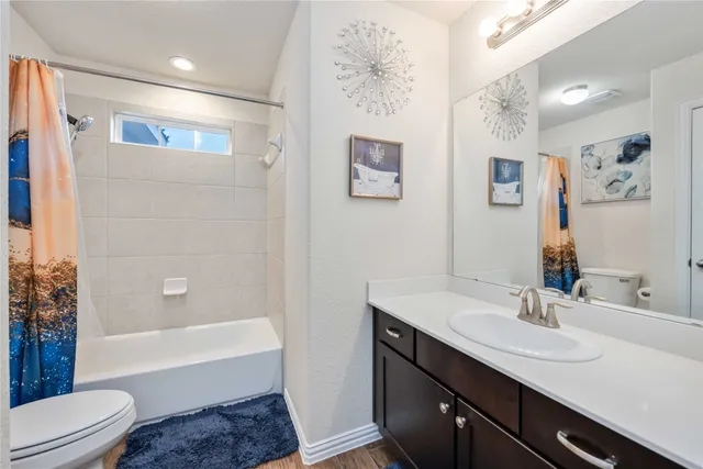 a bathroom with a sink a toilet and bathtub