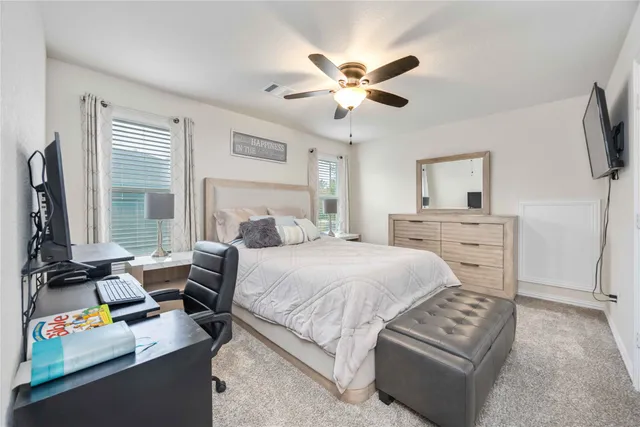 a bedroom with a bed furniture and a flat screen tv