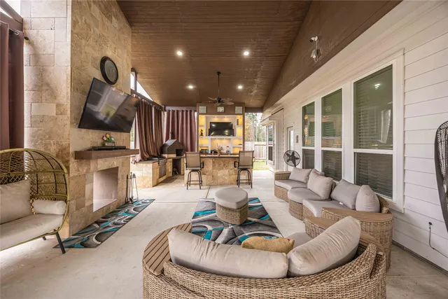 a living room with furniture gym equipment and a fireplace