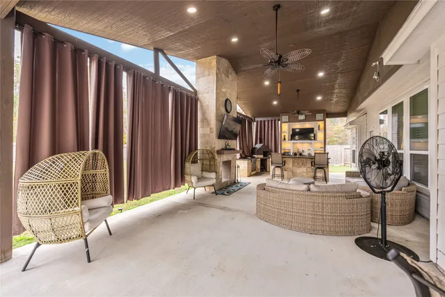 a living room with furniture a ceiling fan and a rug