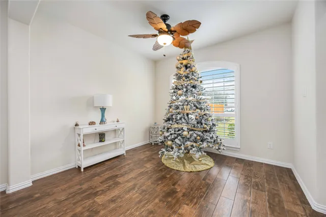 a view of a dining room with a table and chandelier