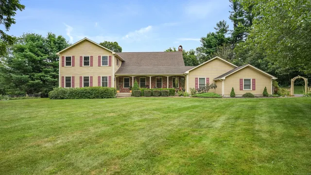 a front view of a house with a garden