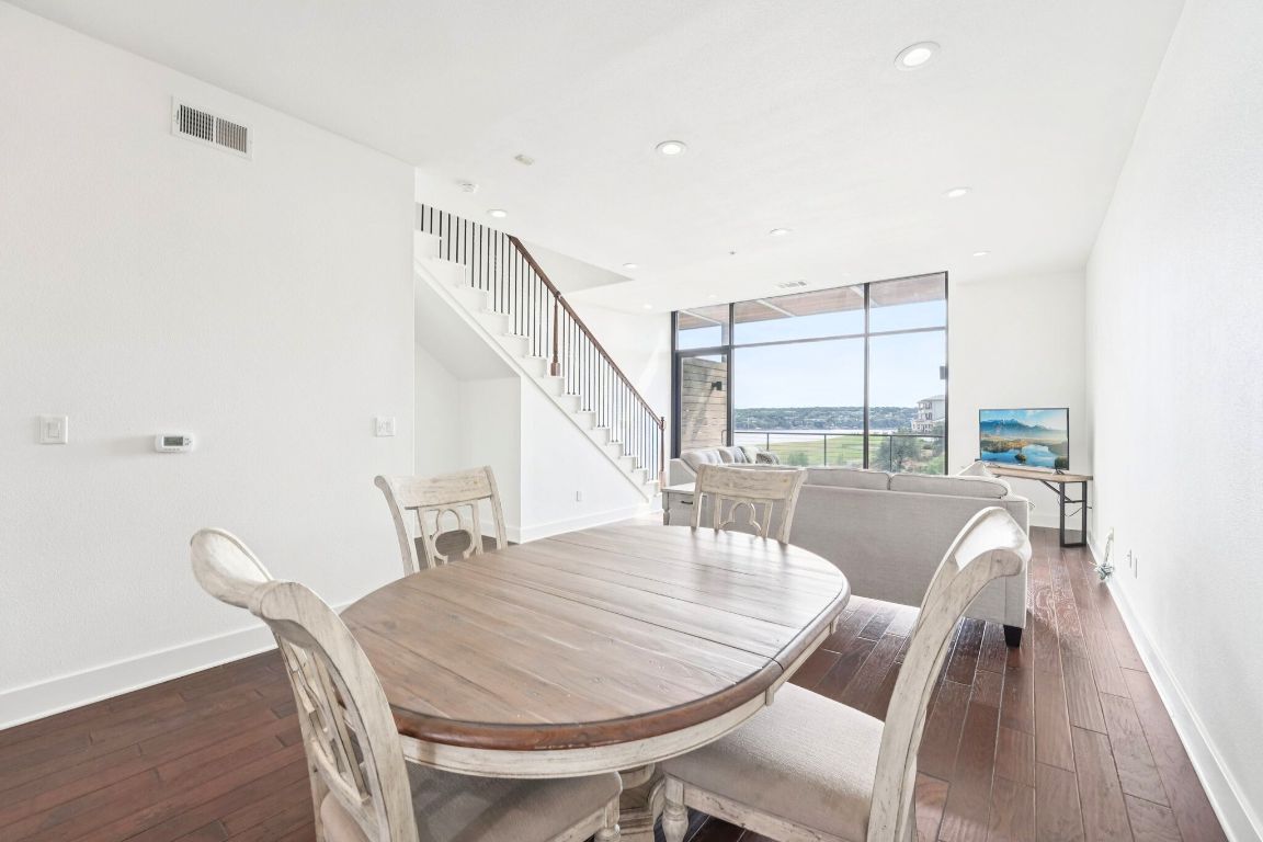 1101 Ivean Pearson Road, Unit E203 Lago Vista, TX 78645 - Photo 14 of 29 a dining room with furniture and wooden floor