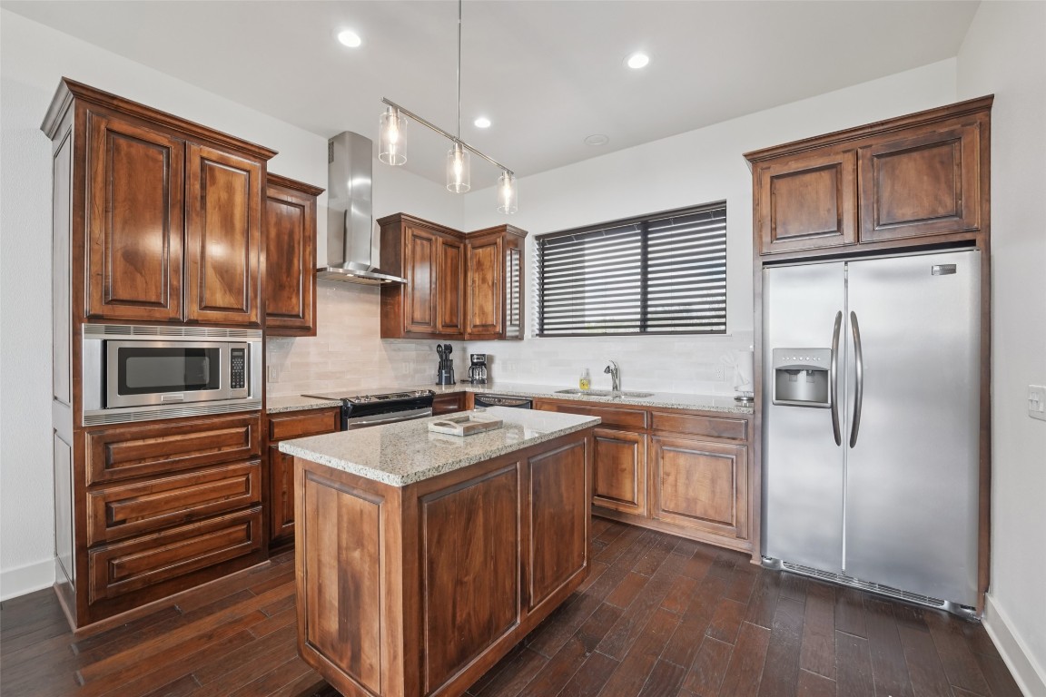 1101 Ivean Pearson Road, Unit E203 Lago Vista, TX 78645 - Photo 17 of 29 a kitchen with stainless steel appliances granite countertop a refrigerator sink and stove