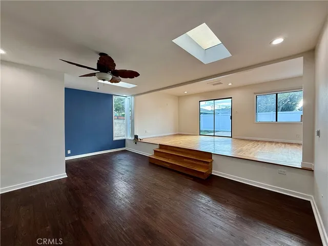 a view of room with wooden floor and window