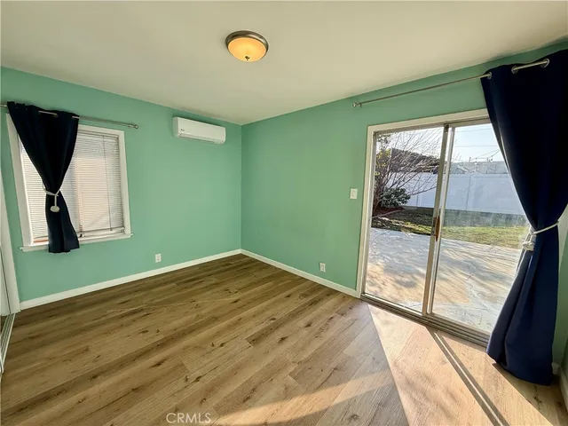 a view of a room with wooden floor and a window