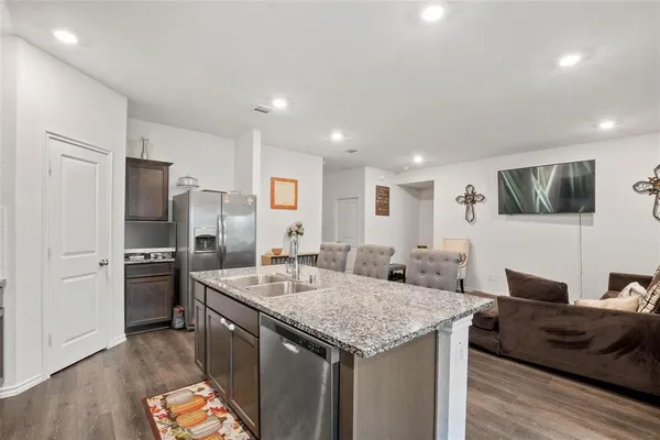 a kitchen with a refrigerator sink and stove