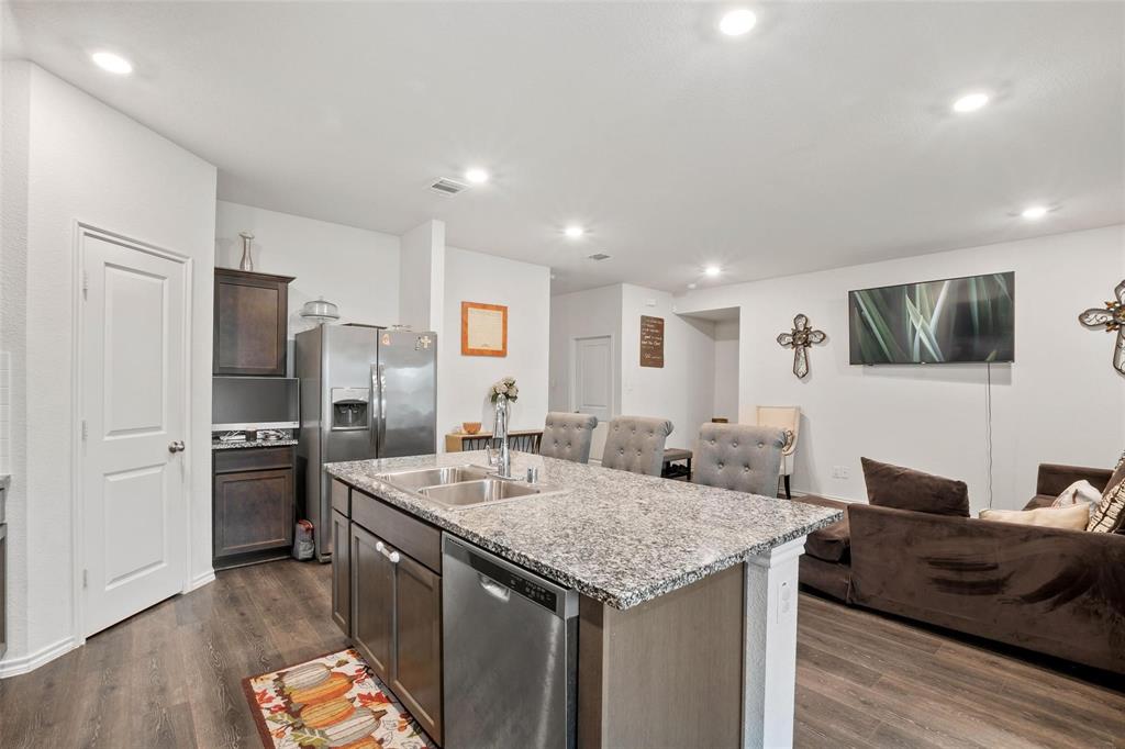 151 Seabiscuit Road Caddo Mills, TX 75135 - Photo 12 of 40 a kitchen with a refrigerator sink and stove