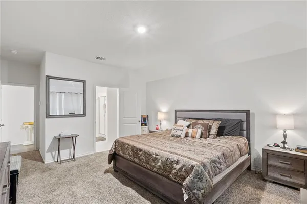 a bedroom with a bed a table and chair