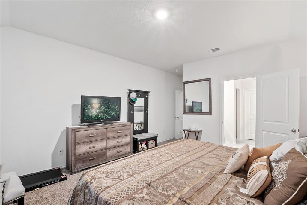 151 Seabiscuit Road Caddo Mills, TX 75135 - Photo 16 of 40 a bedroom with bed and tv with wooden floor