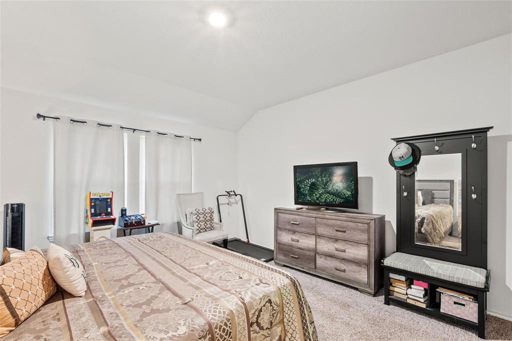 151 Seabiscuit Road Caddo Mills, TX 75135 - Photo 17 of 40 a bedroom with a bed a television and dresser