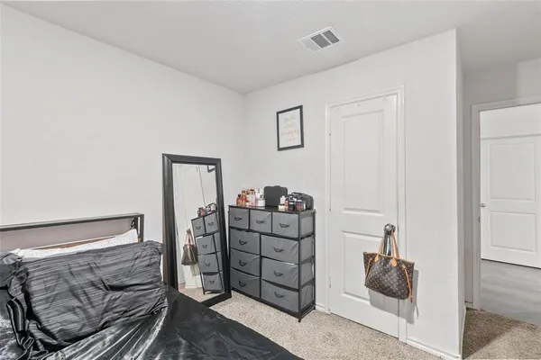 a bedroom with a bed and a dresser