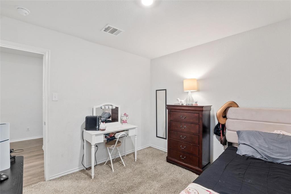 151 Seabiscuit Road Caddo Mills, TX 75135 - Photo 24 of 40 a room that has a dresser and a chair in it