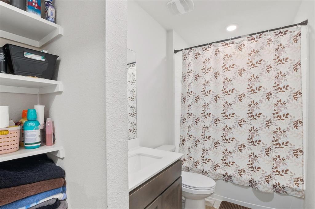 151 Seabiscuit Road Caddo Mills, TX 75135 - Photo 26 of 40 a bathroom with a toilet and a shower curtain
