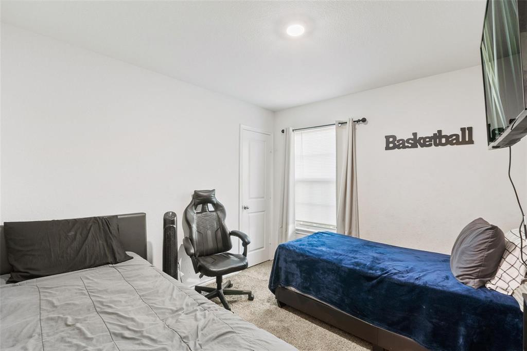 151 Seabiscuit Road Caddo Mills, TX 75135 - Photo 28 of 40 a bedroom with a bed and a window