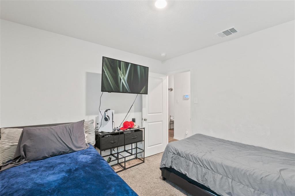 151 Seabiscuit Road Caddo Mills, TX 75135 - Photo 29 of 40 a bedroom with a bed and a couch