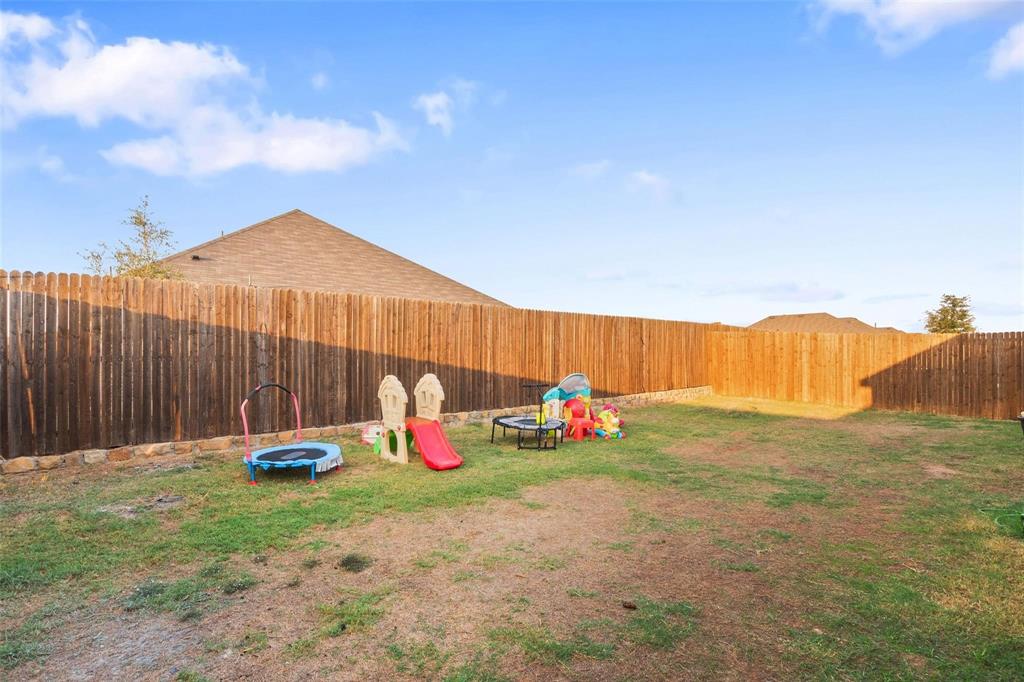 151 Seabiscuit Road Caddo Mills, TX 75135 - Photo 32 of 40 a backyard of a house with table and chairs