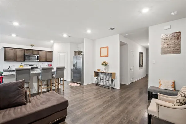 a living room with stainless steel appliances kitchen island granite countertop furniture and a view of kitchen