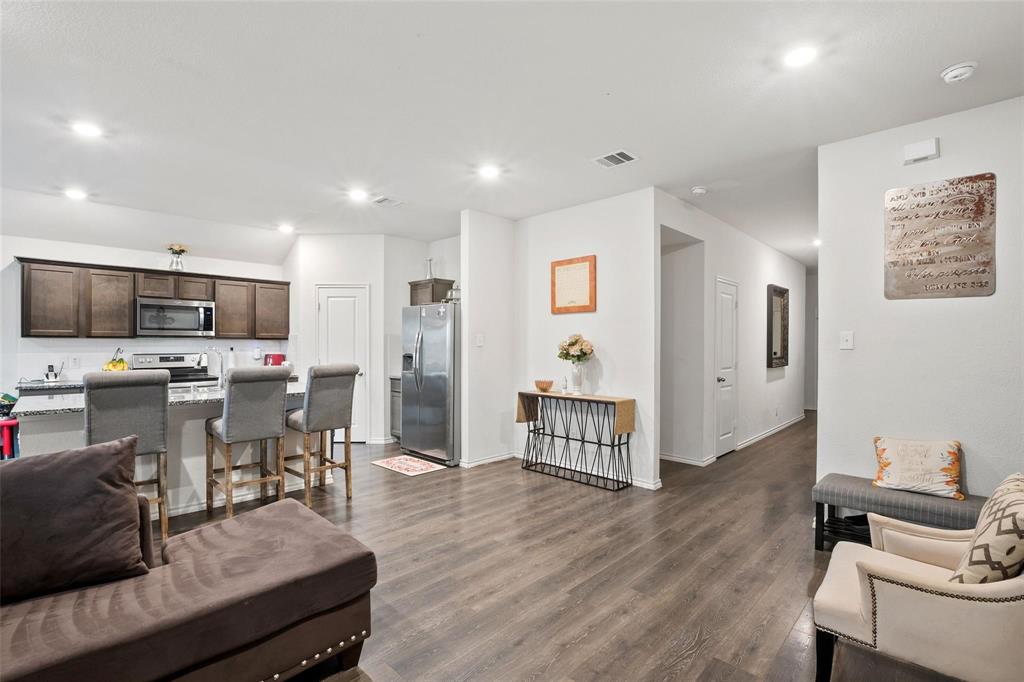 151 Seabiscuit Road Caddo Mills, TX 75135 - Photo 6 of 40 a living room with stainless steel appliances kitchen island granite countertop furniture and a view of kitchen