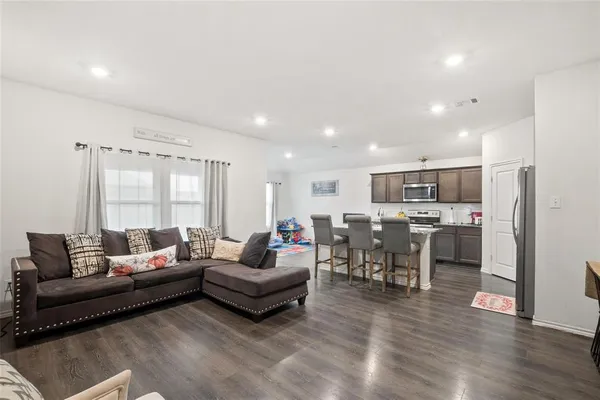 a living room with furniture and kitchen view