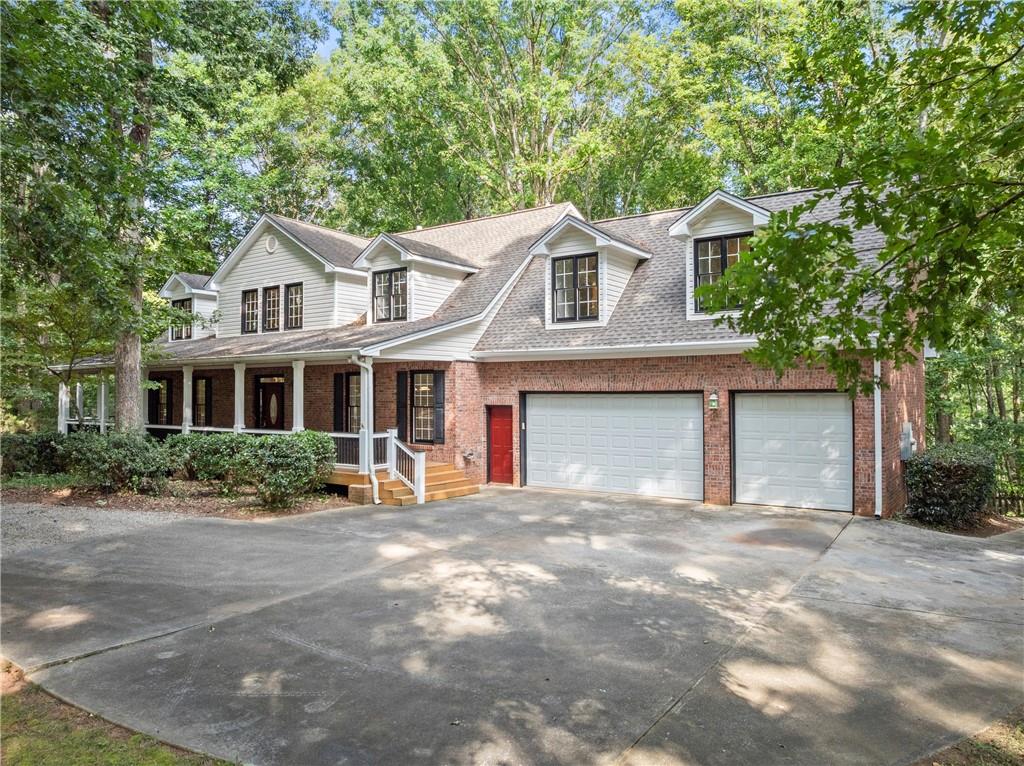 1040 Auburn Road Dacula, GA 30019 - Photo 3 of 42 a front view of a house with a garden