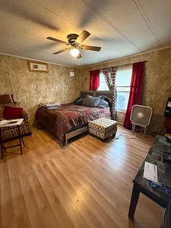 a spacious bedroom with a bed and window