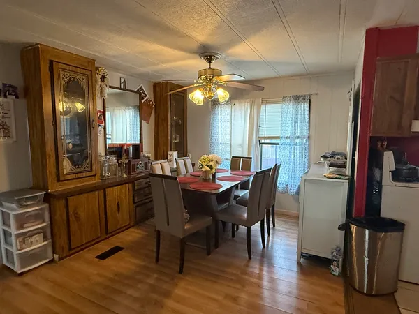 a view of a dining room with furniture and wooden floor