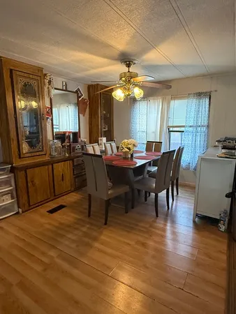a view of a dining room with furniture window and wooden floor