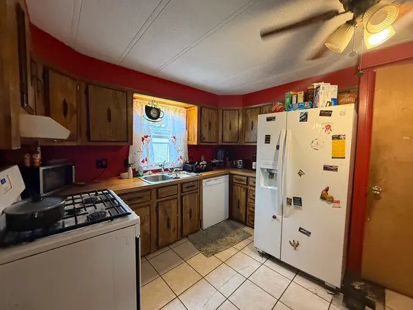 a kitchen with stainless steel appliances granite countertop a refrigerator and a stove