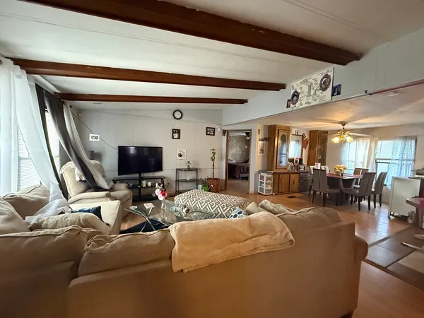 a living room with furniture and a flat screen tv