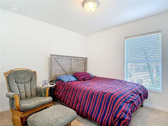 a bedroom with a bed and chair