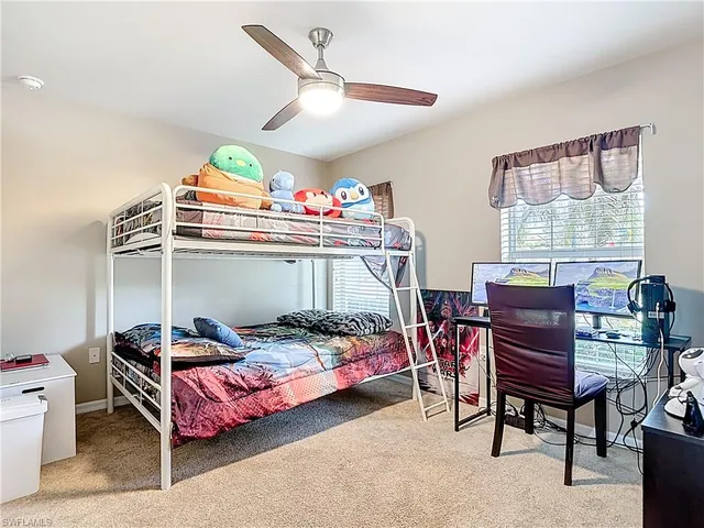 a bedroom with a bed and a desk