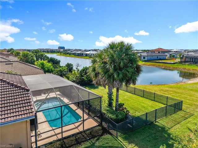 an aerial view of residential houses with outdoor space and swimming pool