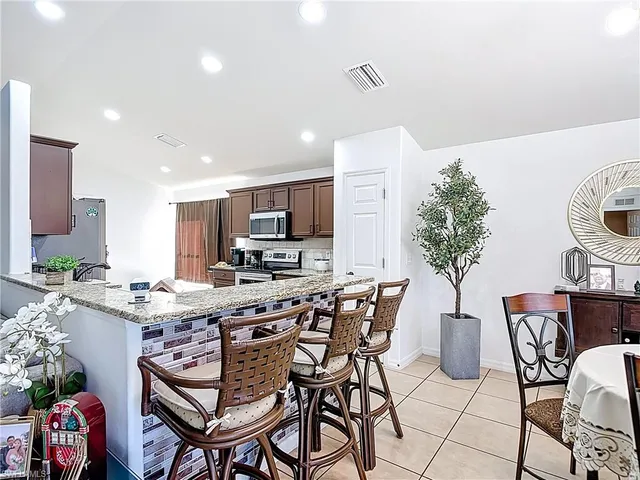 a view of a dining room with furniture and a potted plant
